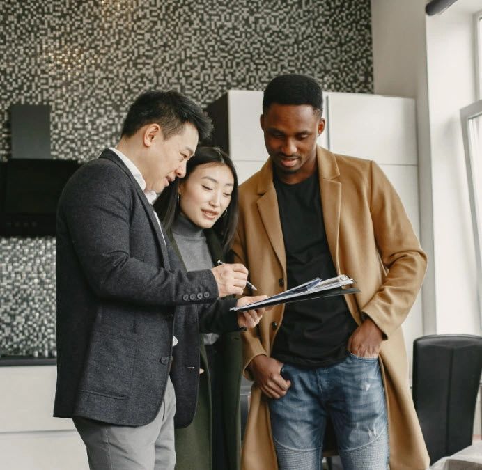 Three professionals reviewing a document in a modern office